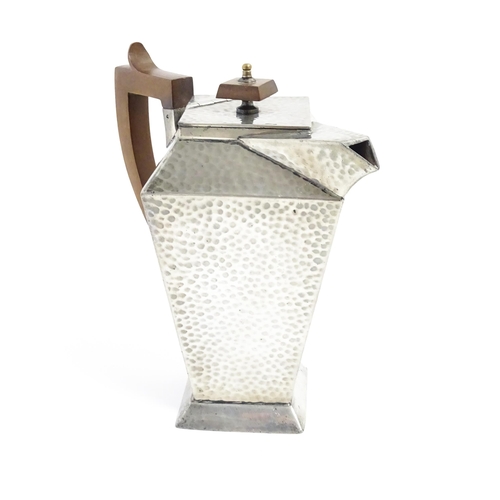 1051 - An Arts and Crafts pewter coffee pot of squared form with hammered decoration, and wooden handle and... 