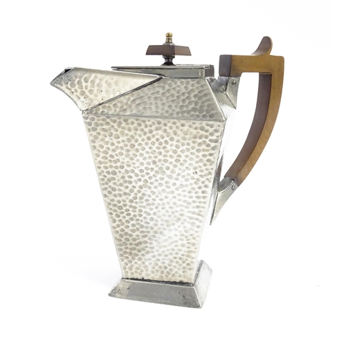 1051 - An Arts and Crafts pewter coffee pot of squared form with hammered decoration, and wooden handle and... 