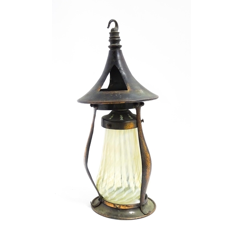 1055 - An Arts & Crafts copper pendant light frame of lantern form, the copper supports with hammered decor... 