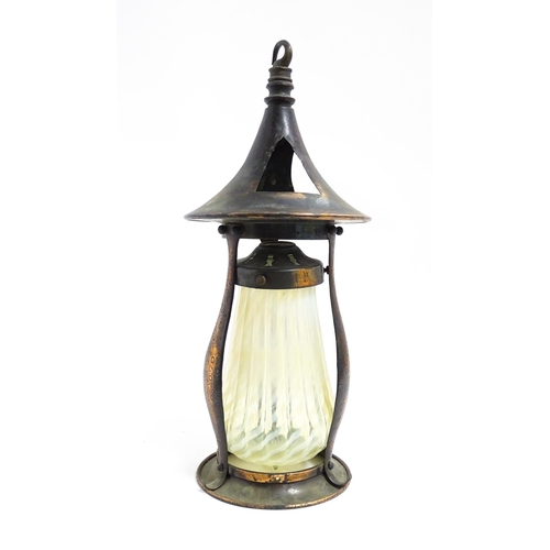 1055 - An Arts & Crafts copper pendant light frame of lantern form, the copper supports with hammered decor... 