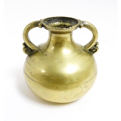 1056 - An Asian brass twin handled vase with banded detail. Approx. 3 1/2