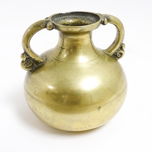 1056 - An Asian brass twin handled vase with banded detail. Approx. 3 1/2