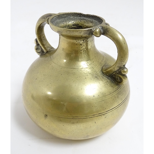 1056 - An Asian brass twin handled vase with banded detail. Approx. 3 1/2