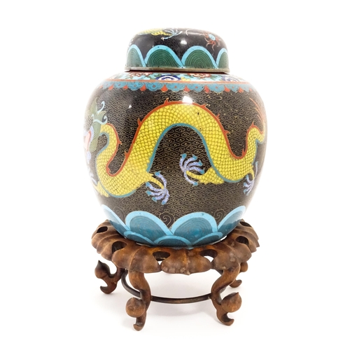 1057 - A Chinese cloisonne ginger jar with a black ground decorated with dragons and a flaming pearl. Toget... 