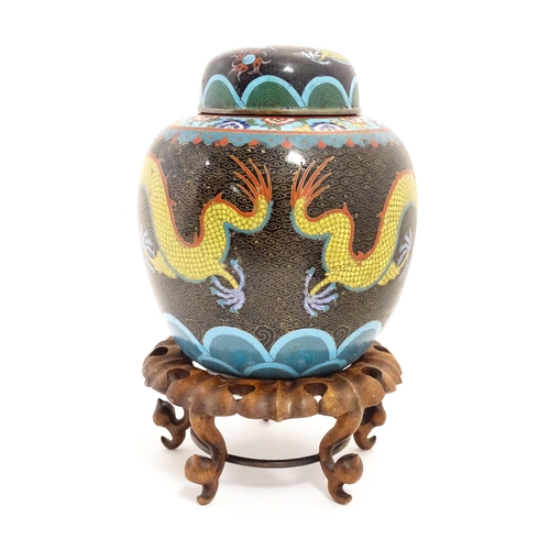 1057 - A Chinese cloisonne ginger jar with a black ground decorated with dragons and a flaming pearl. Toget... 