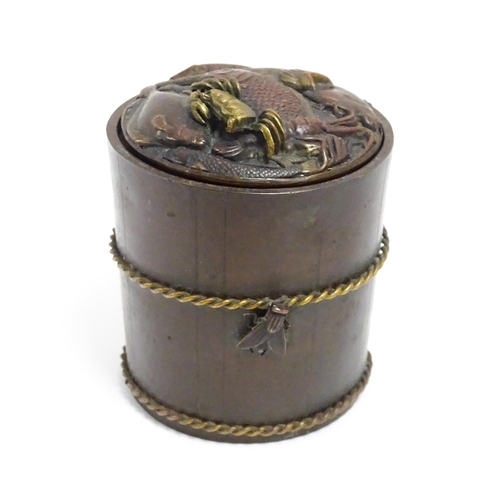 1060 - A Japanese bronze novelty inkwell of cylindrical form, the lid with fish and crab detail, the body w... 