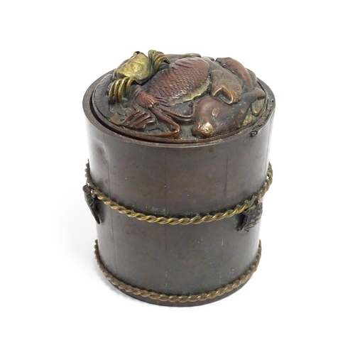 1060 - A Japanese bronze novelty inkwell of cylindrical form, the lid with fish and crab detail, the body w... 