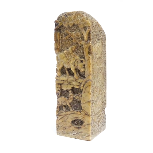 1061 - An Oriental soapstone carving depicting a rocky landscape scene with a water buffalo with a figure o... 