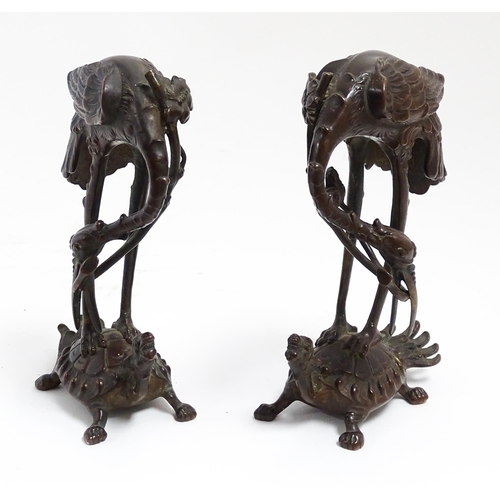 1062 - A pair of Japanese cast sculptures modelled as a stylised crane standing on a tortoise. Approx. 7 1/... 