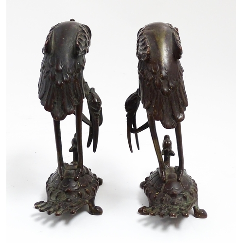 1062 - A pair of Japanese cast sculptures modelled as a stylised crane standing on a tortoise. Approx. 7 1/... 