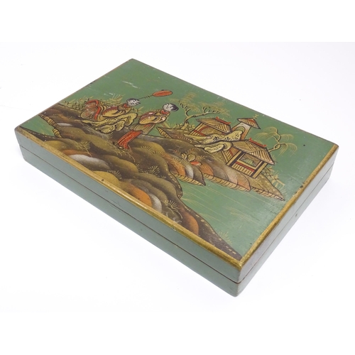 1068 - A 20thC cigarette box with chinoiserie decoration depicting two figures in a landscape with pagoda s... 