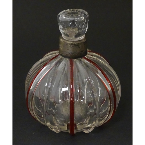 240 - An early 20thC glass scent / perfume bottle with red glass detail and silver collar hallmarked Birmi... 