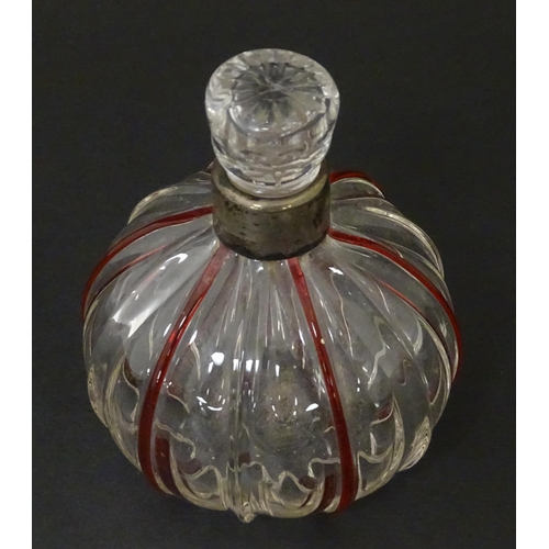 240 - An early 20thC glass scent / perfume bottle with red glass detail and silver collar hallmarked Birmi... 