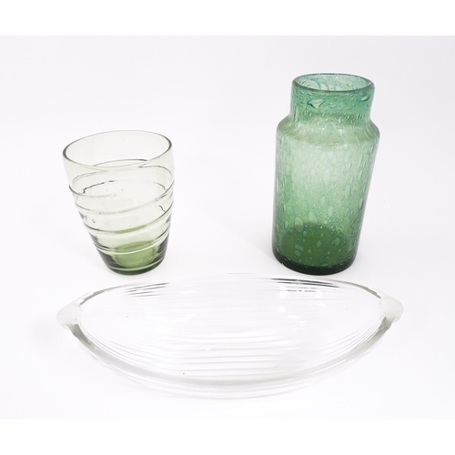 250 - Three items of glassware to include a trailed green glass vase, a green soda glass jar / vase, and a... 