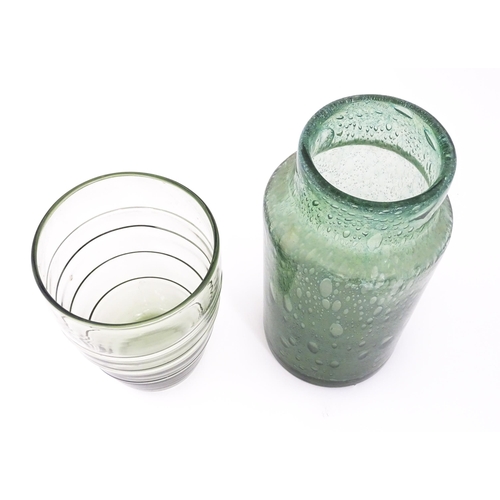 250 - Three items of glassware to include a trailed green glass vase, a green soda glass jar / vase, and a... 