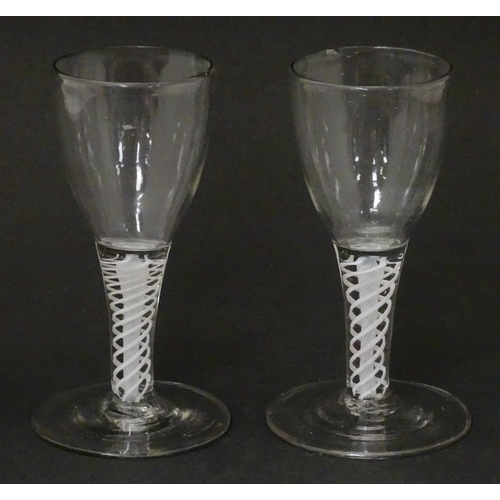 257 - Two 18th / 19thC pedestal drinking glasses with twist detail to stems. Approx. 5