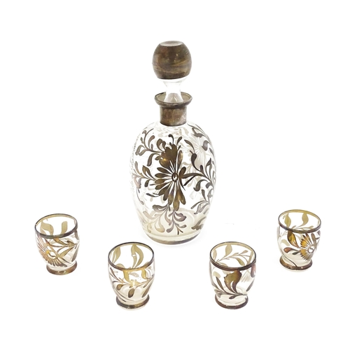 259 - A Schnapps decanter together with four glasses with lustre detail. The decanter 9