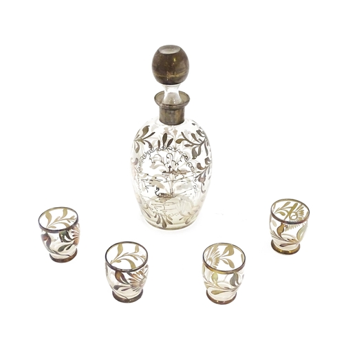 259 - A Schnapps decanter together with four glasses with lustre detail. The decanter 9