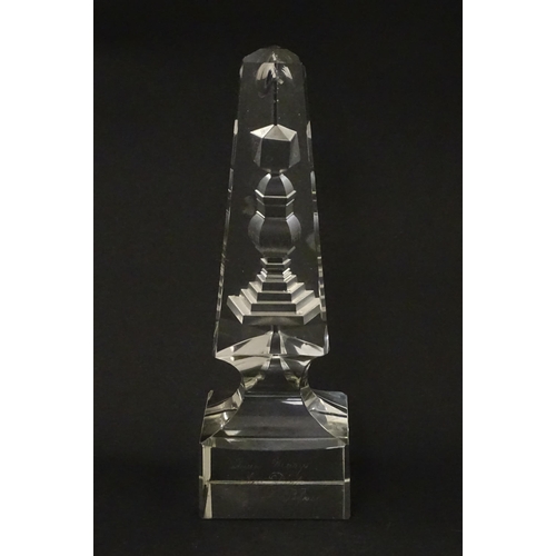 262 - A 19thC cut glass obelisk / prism with urn detail to centre. Approx. 6 3/4