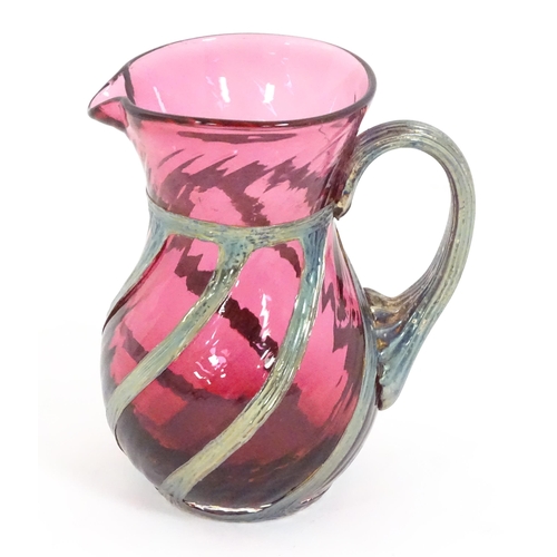 263 - A cranberry glass jug with silver overlay detail by Sileda Ltd. Approx. 3 3/4