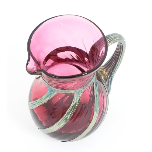 263 - A cranberry glass jug with silver overlay detail by Sileda Ltd. Approx. 3 3/4