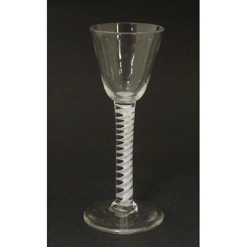 267 - An 18thC wine glass with multi-ply corkscrew twist stem. Approx. 6