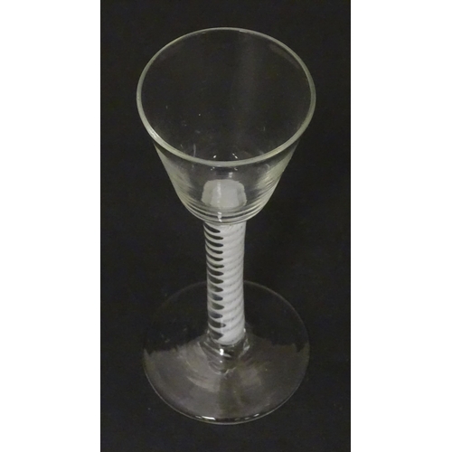 267 - An 18thC wine glass with multi-ply corkscrew twist stem. Approx. 6