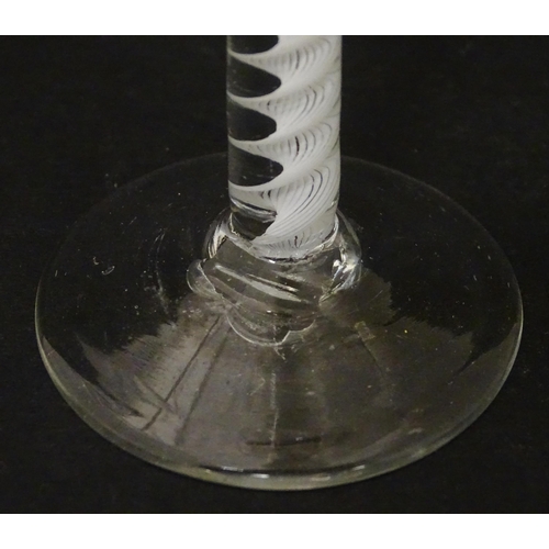 267 - An 18thC wine glass with multi-ply corkscrew twist stem. Approx. 6