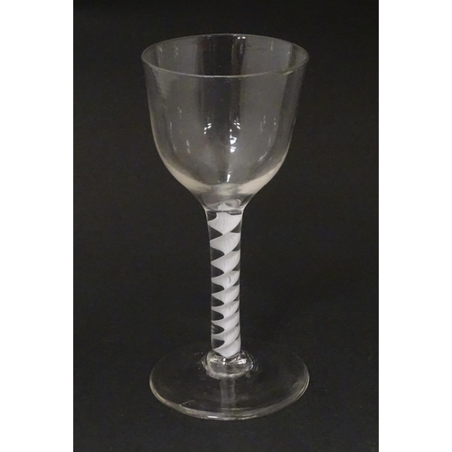 268 - An 18thC wine glass with ogee bowl, multi-ply corkscrew twist stem. Approx. 6 1/2