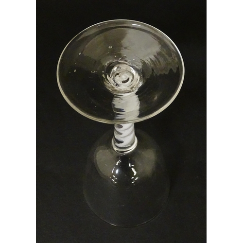 268 - An 18thC wine glass with ogee bowl, multi-ply corkscrew twist stem. Approx. 6 1/2