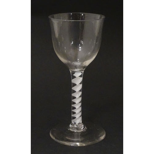 268 - An 18thC wine glass with ogee bowl, multi-ply corkscrew twist stem. Approx. 6 1/2