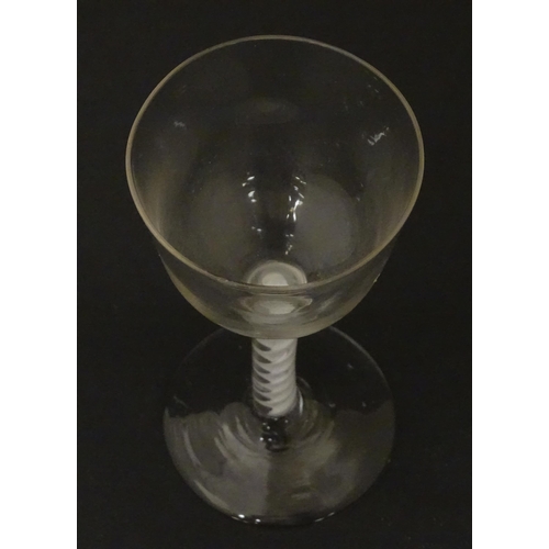 268 - An 18thC wine glass with ogee bowl, multi-ply corkscrew twist stem. Approx. 6 1/2