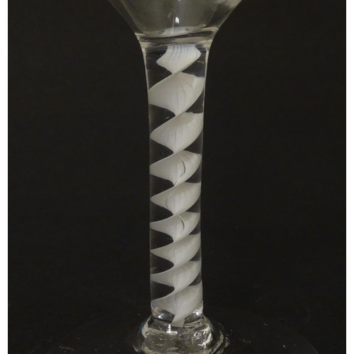 268 - An 18thC wine glass with ogee bowl, multi-ply corkscrew twist stem. Approx. 6 1/2