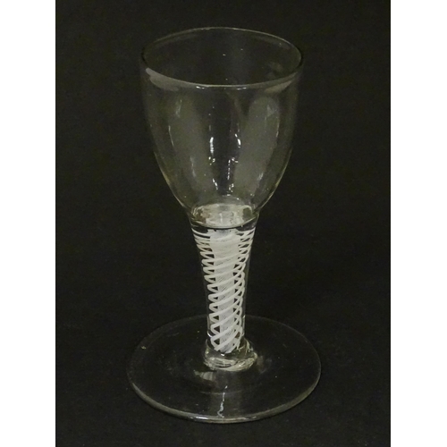 269 - An 18thC funnel bowl wine glass with opaque twist stem. Approx. 4 3/4