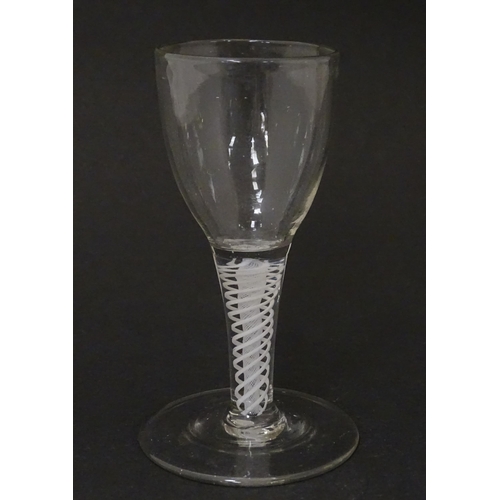 269 - An 18thC funnel bowl wine glass with opaque twist stem. Approx. 4 3/4