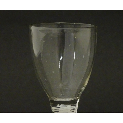 269 - An 18thC funnel bowl wine glass with opaque twist stem. Approx. 4 3/4