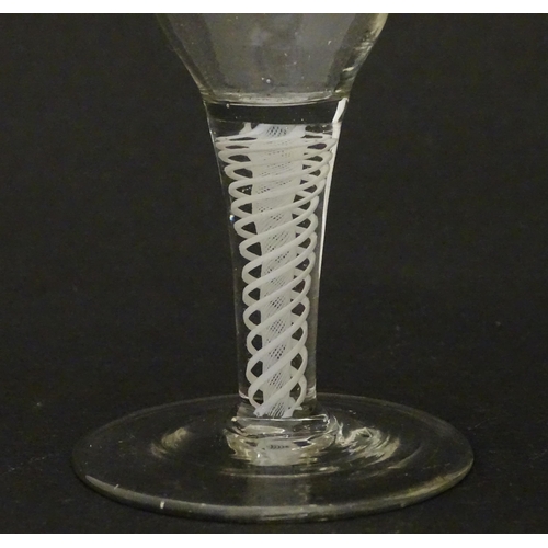 269 - An 18thC funnel bowl wine glass with opaque twist stem. Approx. 4 3/4