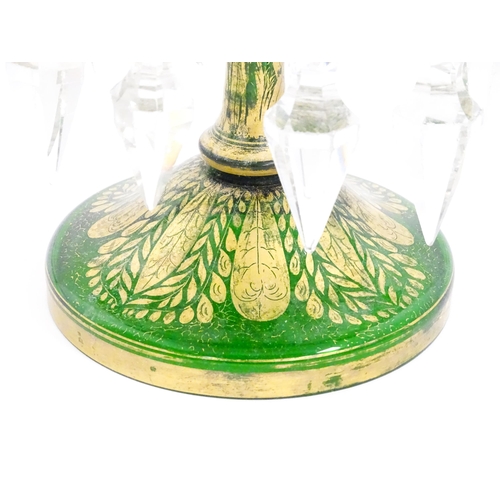 274 - A Victorian green glass table lustre with gilt foliate decoration and clear glass drops. Approx 13 1... 