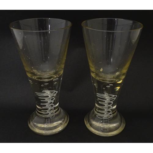 278 - A pair of drinking glasses with twist and bubble detail to stems. Approx. 7 3/4