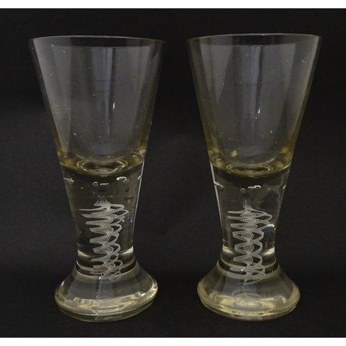 278 - A pair of drinking glasses with twist and bubble detail to stems. Approx. 7 3/4