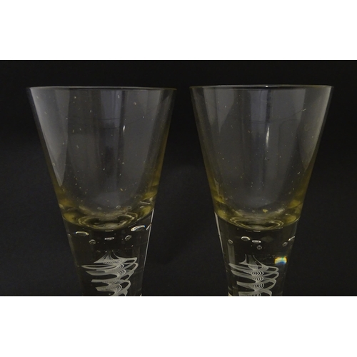 278 - A pair of drinking glasses with twist and bubble detail to stems. Approx. 7 3/4