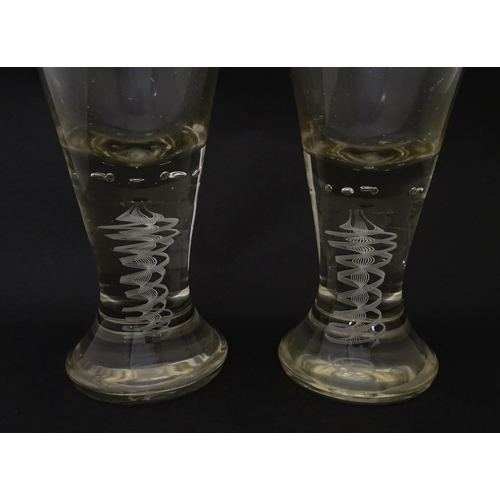 278 - A pair of drinking glasses with twist and bubble detail to stems. Approx. 7 3/4