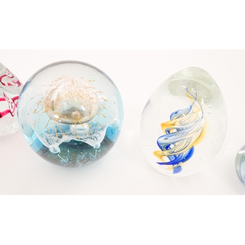 284 - A quantity of assorted glass paperweights etc. to include a Murano example formed as a bird etc. Lar... 