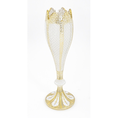 298 - A Victorian Bohemian diamond cut glass vase of pedestal tulip form with white and gilt detail. Appro... 