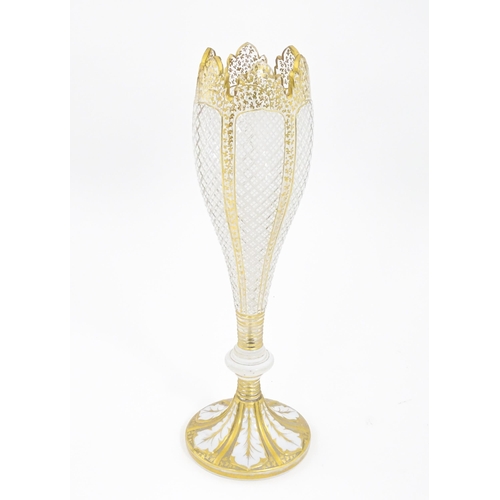 298 - A Victorian Bohemian diamond cut glass vase of pedestal tulip form with white and gilt detail. Appro... 