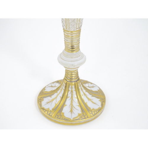 298 - A Victorian Bohemian diamond cut glass vase of pedestal tulip form with white and gilt detail. Appro... 