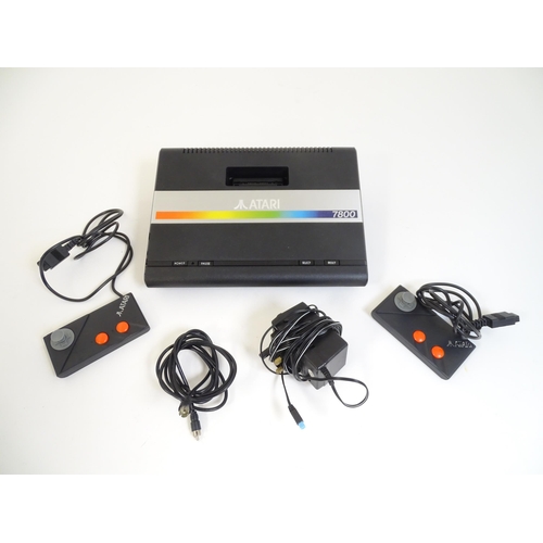 908 - Toys: An Atari 7800 video game console. Together with games cartridges comprising Jinks, Xevious, Po... 