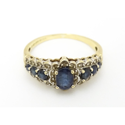 577 - A 9ct gold ring set with sapphires and diamonds. Ring size approx. P