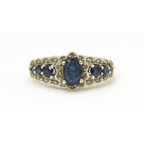 577 - A 9ct gold ring set with sapphires and diamonds. Ring size approx. P