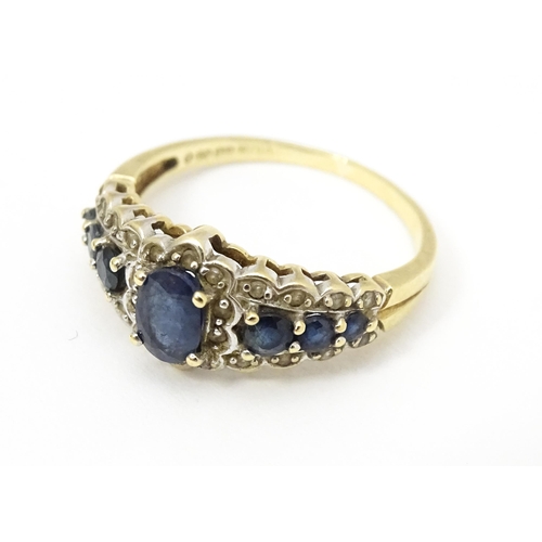 577 - A 9ct gold ring set with sapphires and diamonds. Ring size approx. P